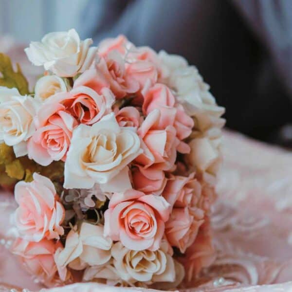 bouquet of flower holded by the bride while sitting beside the groom
